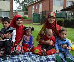 Mums and their children enjoying a picnic together