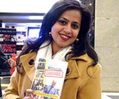 Picture of one of the movie stars holding a copy of the DVD