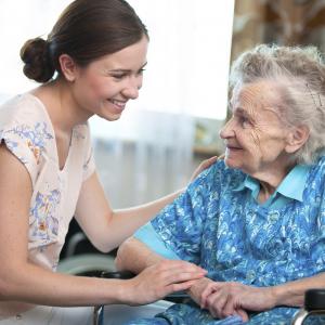 Female volunteer visiting a elderly woman in her home