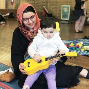 Mother and daughter playing together with musical instruments