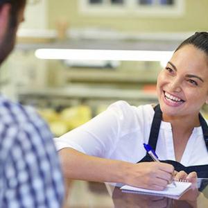 A worker engaging with a customer in a retail shop