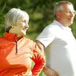 Older man and woman exercising outdoors
