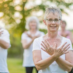 Senior adults doing tai chi in the park