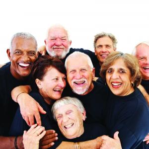 A group of seniors hugging and laughing 