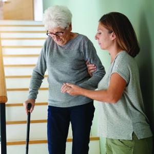 25 March 2019 Carer helps senior woman down stairs
