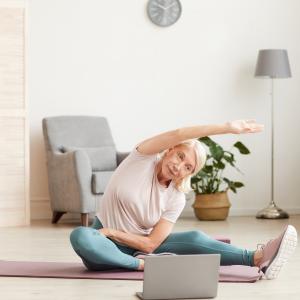 50+ women exercising online in her loungeroom