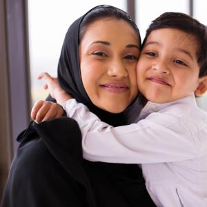 Muslim mum and son hugging