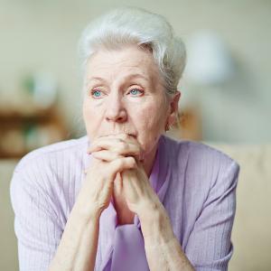 Elderly woman looking sad